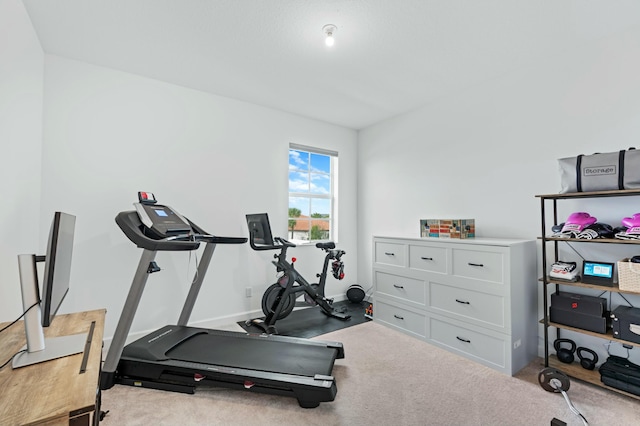 exercise room with light colored carpet