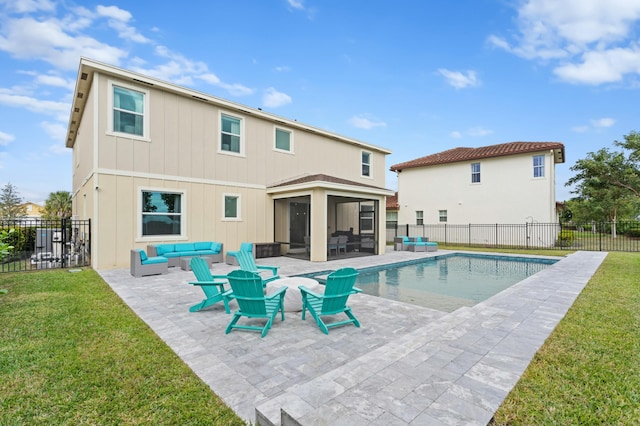 view of swimming pool featuring a lawn, an outdoor hangout area, a patio area, and a sunroom