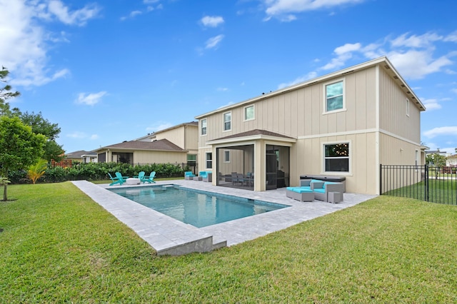 back of property with a sunroom, a yard, an outdoor hangout area, a fenced in pool, and a patio