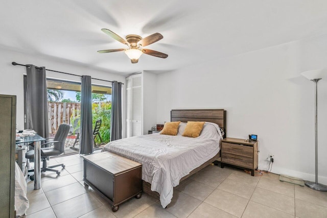 tiled bedroom with ceiling fan, access to exterior, and a closet