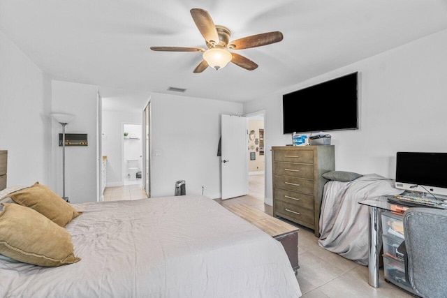 tiled bedroom featuring ensuite bathroom and ceiling fan