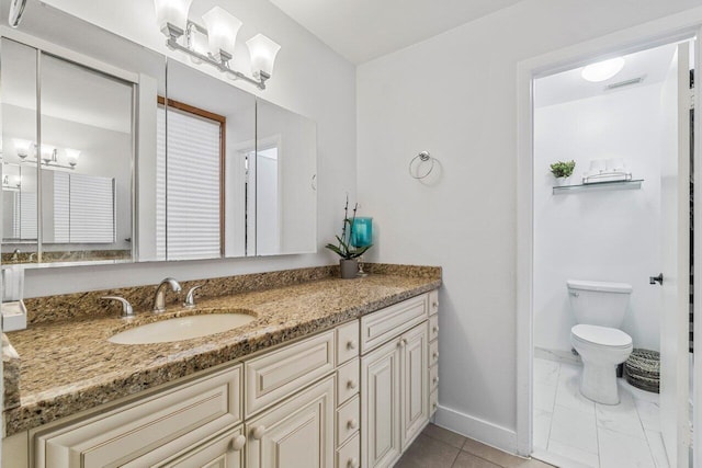 bathroom featuring vanity and toilet