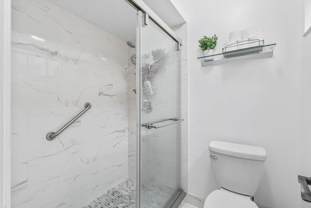 bathroom featuring toilet and an enclosed shower