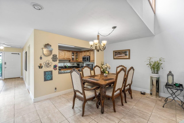 dining space with light tile patterned floors and ceiling fan with notable chandelier