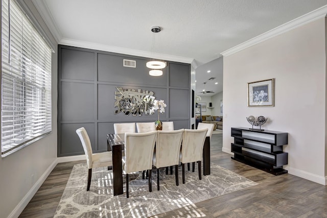 dining room featuring ceiling fan, dark hardwood / wood-style flooring, and ornamental molding