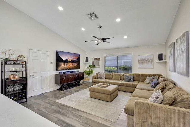 living room with hardwood / wood-style flooring, high vaulted ceiling, and ceiling fan