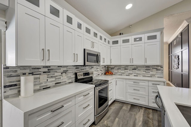 kitchen featuring white cabinetry, lofted ceiling, and stainless steel appliances