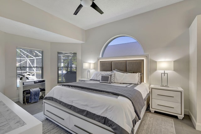 bedroom with ceiling fan and light tile patterned floors