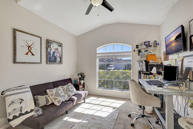 carpeted office with ceiling fan, a textured ceiling, and vaulted ceiling