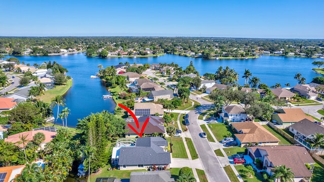 birds eye view of property with a water view