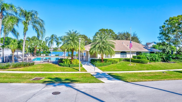 view of front of house featuring a front yard and a community pool