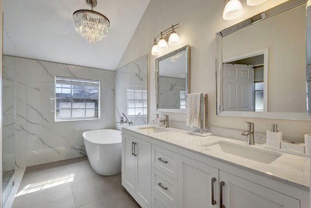 bathroom featuring vanity, vaulted ceiling, a notable chandelier, and separate shower and tub