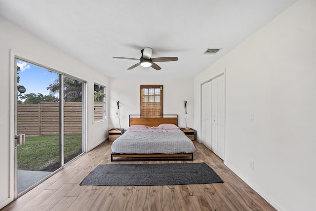 bedroom featuring access to exterior, a closet, ceiling fan, and light wood-type flooring