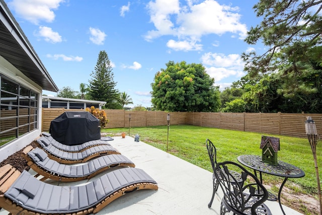 view of patio featuring a sunroom and area for grilling