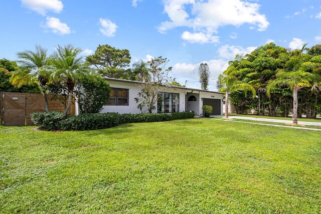 view of front of home featuring a garage and a front lawn