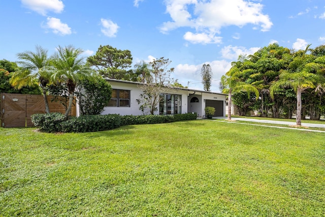 ranch-style home with a garage and a front yard