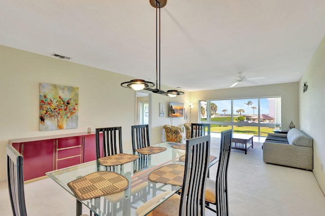 carpeted dining area featuring ceiling fan