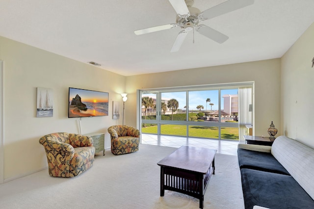 carpeted living room with ceiling fan