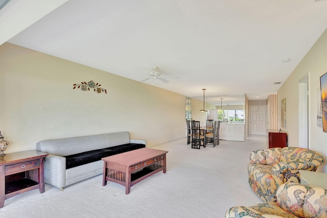 carpeted living room with ceiling fan