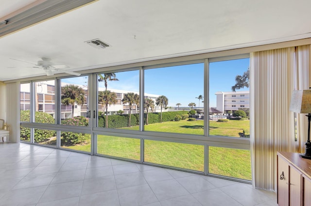 unfurnished sunroom featuring ceiling fan