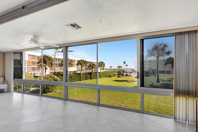 unfurnished sunroom featuring ceiling fan