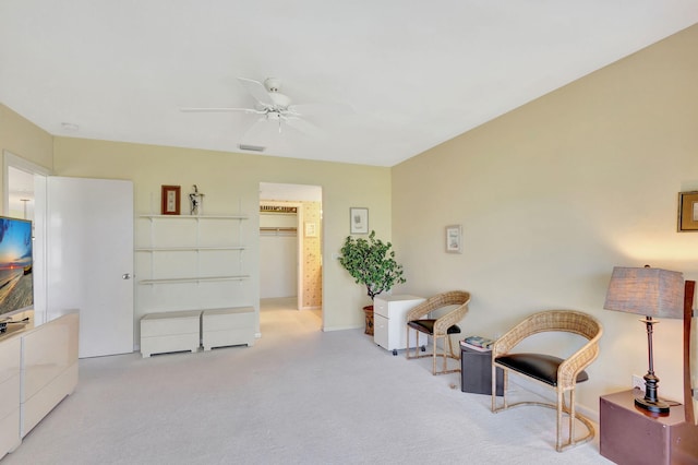 sitting room with light carpet and ceiling fan