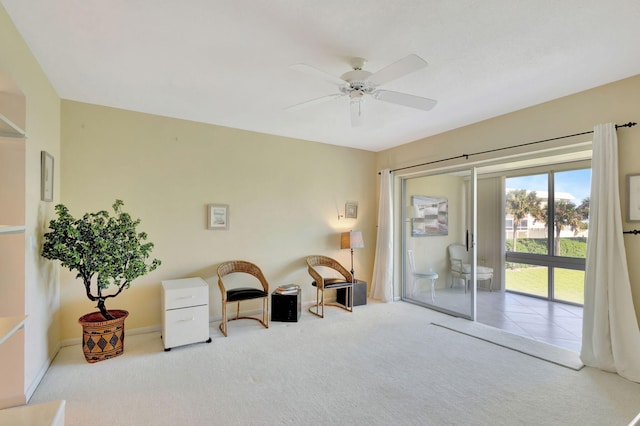 sitting room featuring ceiling fan and light colored carpet