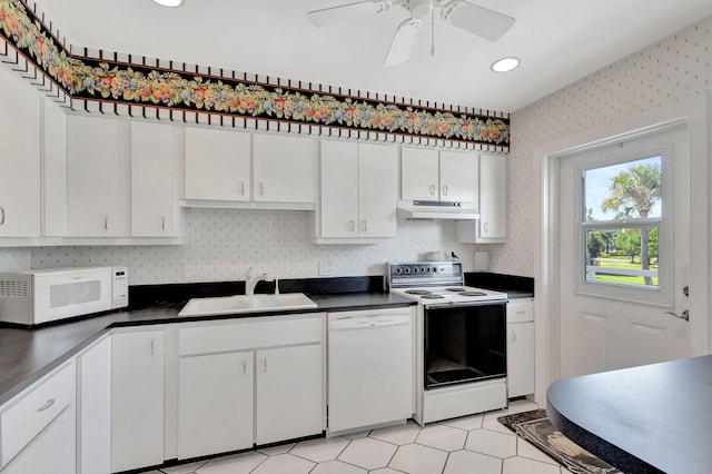 kitchen with white appliances, white cabinetry, ceiling fan, and sink