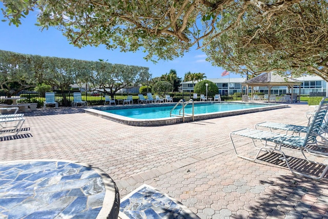 view of swimming pool featuring a gazebo and a patio area