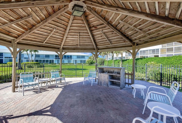 view of patio / terrace featuring a gazebo and an outdoor bar