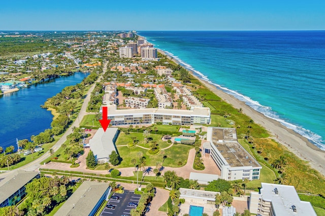 aerial view with a water view and a beach view