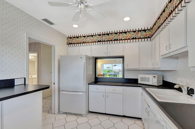 kitchen with white cabinets, ceiling fan, white appliances, and sink