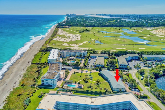 bird's eye view with a water view and a beach view