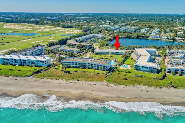 drone / aerial view featuring a view of the beach and a water view