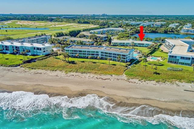 drone / aerial view featuring a water view and a view of the beach