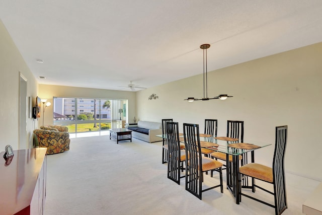 dining room featuring ceiling fan and light carpet