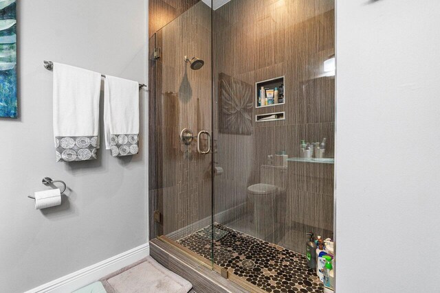 bathroom with a shower with door