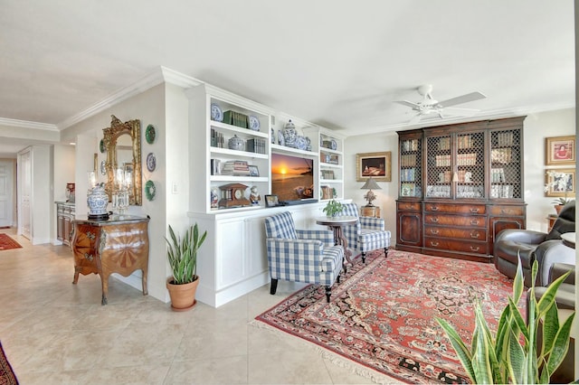 living area featuring built in shelves, crown molding, light tile patterned floors, and ceiling fan