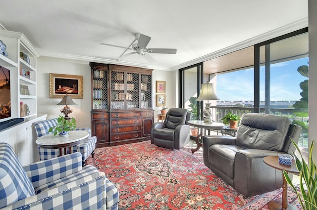 living room with ceiling fan, a wall of windows, and ornamental molding