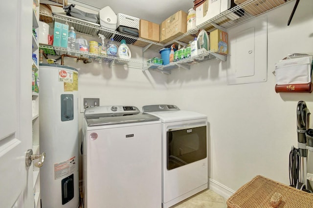 laundry area featuring washing machine and dryer, electric water heater, and light tile patterned floors