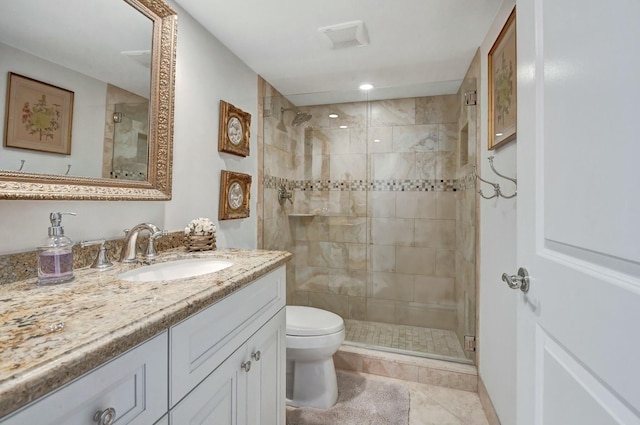 bathroom with tile patterned flooring, vanity, an enclosed shower, and toilet