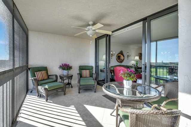 sunroom featuring ceiling fan