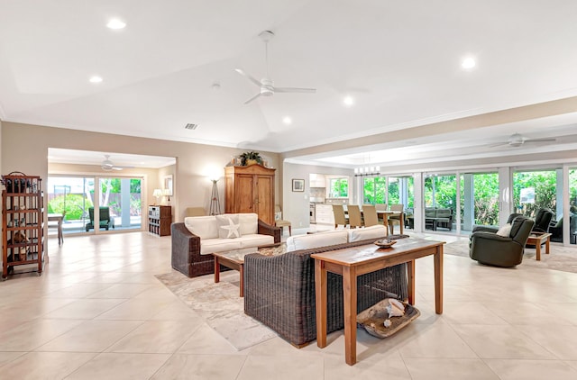 tiled living room featuring a healthy amount of sunlight, ornamental molding, and lofted ceiling