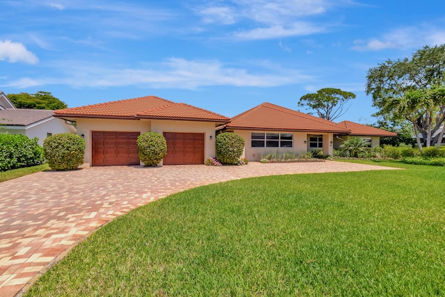 view of front facade with a front yard and a garage