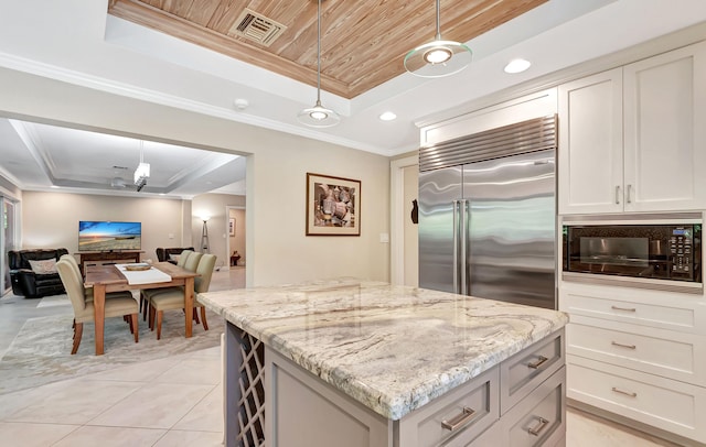 kitchen with wooden ceiling, pendant lighting, a tray ceiling, and built in appliances