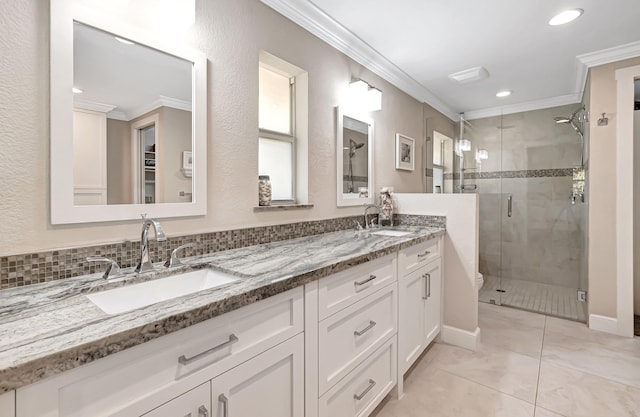 bathroom featuring vanity, crown molding, and a shower with door