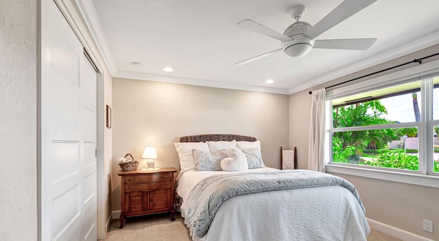 bedroom featuring ceiling fan, light colored carpet, a closet, and crown molding