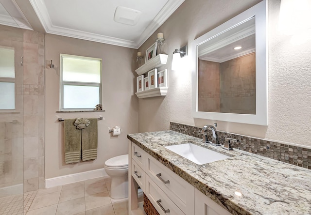 bathroom with toilet, vanity, crown molding, and tiled shower