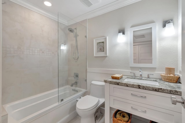 full bathroom with tiled shower / bath combo, vanity, crown molding, and toilet