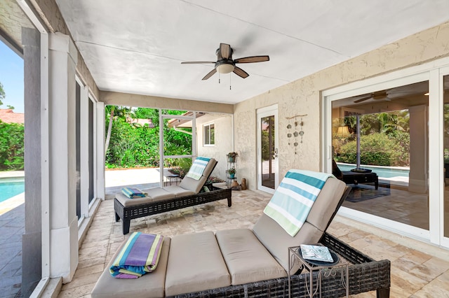 sunroom with ceiling fan